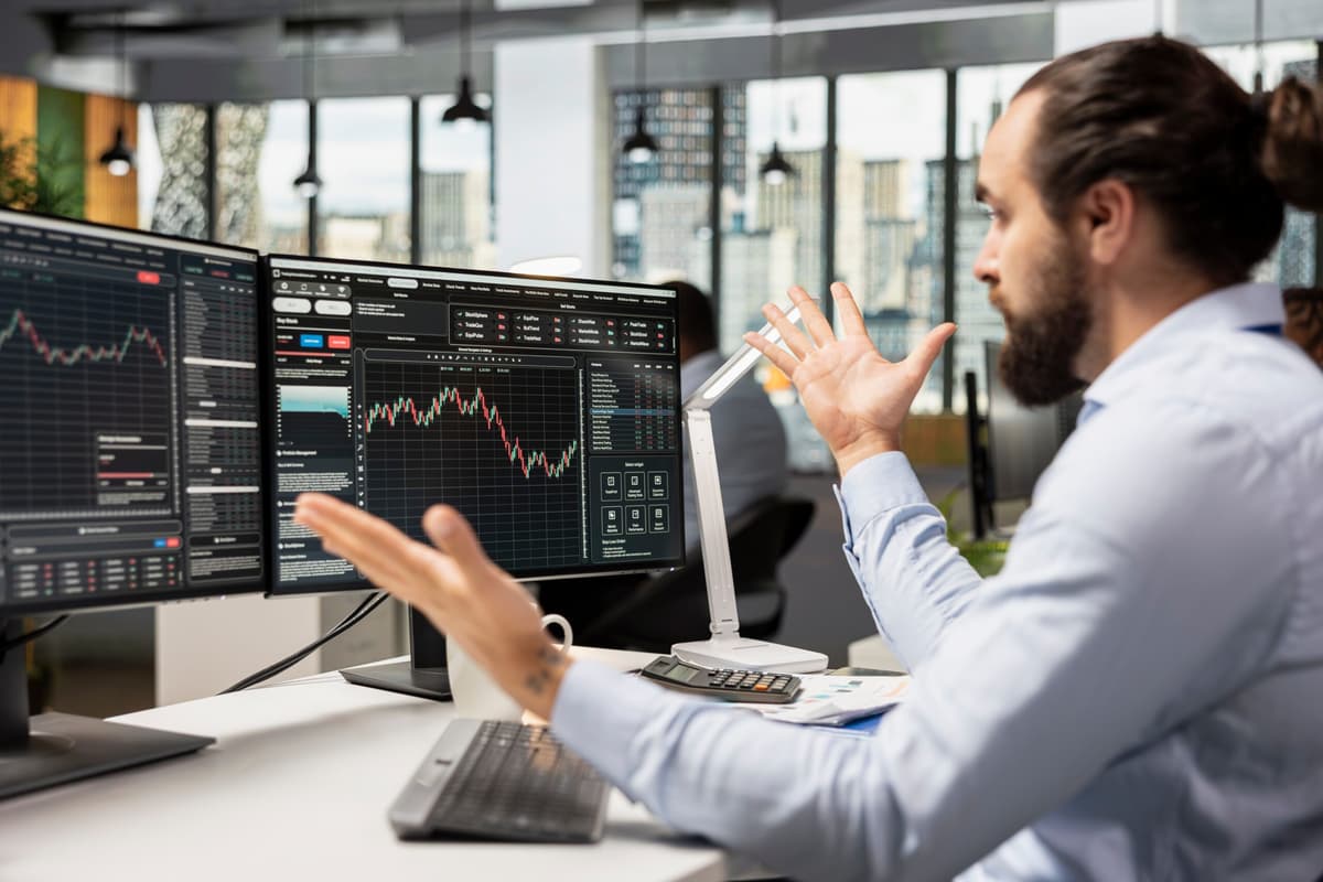 a trader watching the stock market with technical analysis charts